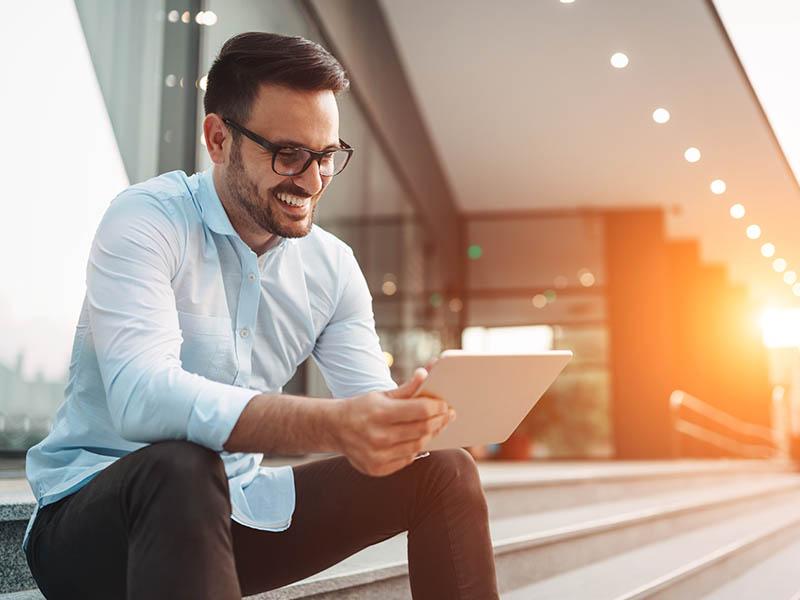 Man on tablet paying bills